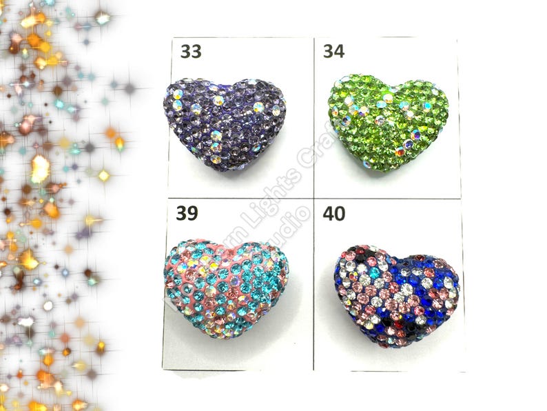 May include: Four heart-shaped rhinestone embellishments in different colors: purple, green, pink, and blue. The rhinestones are arranged in a grid pattern on a white background. The numbers 33, 34, 39, and 40 are printed above each embellishment.