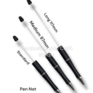 May include: A white ceramic mug with a black handle and the text "But First, Coffee" in a black, bold font. The mug is on a white surface.