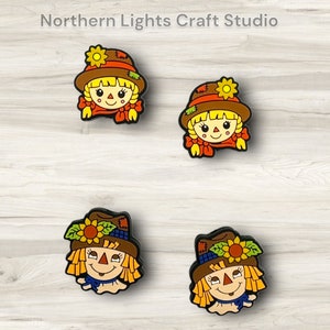 May include: Four colorful cartoon scarecrow faces with brown hats, yellow hair, and orange and blue accents.  Northern Lights Craft Studio.