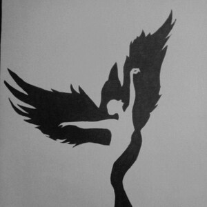May include: A black and white illustration of a phoenix rising. The design features a silhouette of a person with outstretched arms, integrated into the shape of a bird with large, detailed wings. The artwork is set against a plain background.