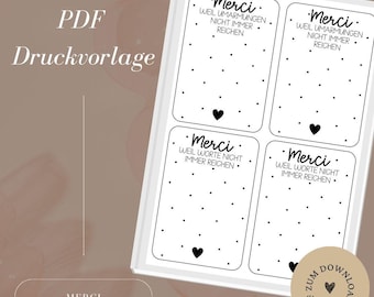May include: Printable PDF template with four cards that say "Merci" in black text. Each card has a black heart at the bottom and a dotted pattern. The text on the cards reads "Merci, Weil Umarmungen nicht immer reichen" and "Merci, Weil Worte nicht immer reichen".