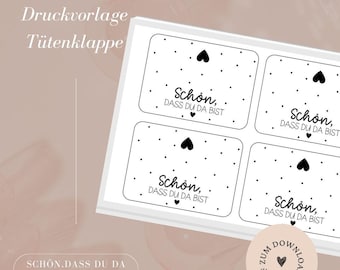 May include: Four printable gift tags with a black and white polka dot pattern and a black heart. The text on each tag reads "Schon, dass du da bist" which translates to "Nice, that you are here".