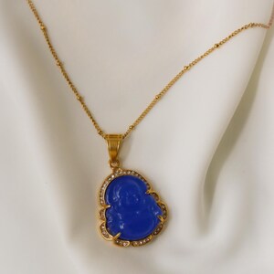 a gold necklace with a blue pendant and a gold chain.