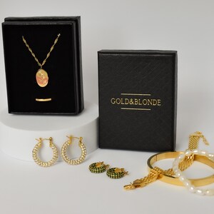 a jewelry box with a necklace, bracelet, and earrings