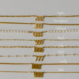 a collection of various gold necklaces with different pendants, each with a unique number. The pendants are arranged in a row, and the necklaces are labeled with their corresponding numbers.