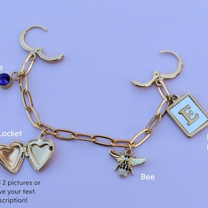a gold bracelet with charms and a bee