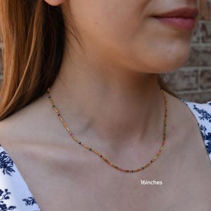 a close up of a woman wearing a necklace