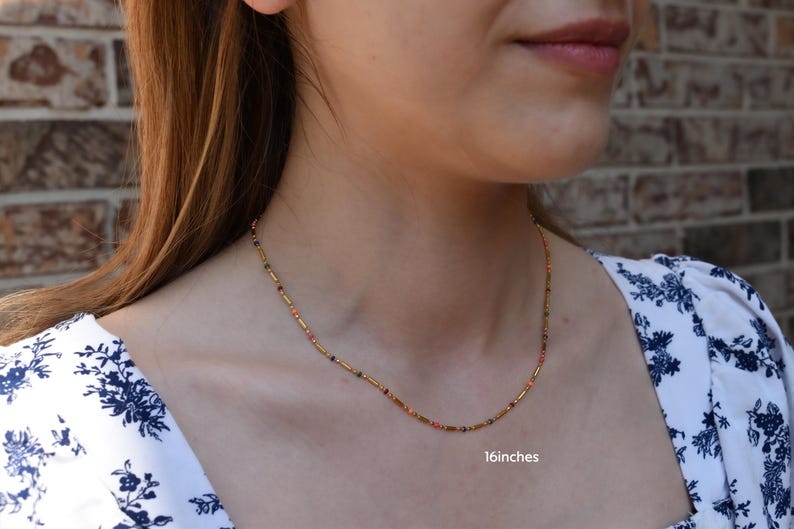 a close up of a woman wearing a necklace
