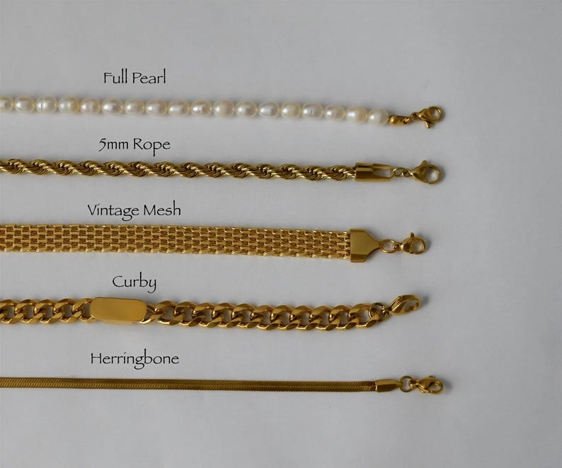 a collection of five gold-colored bracelets, each with a different design and clasp style, arranged in a row.