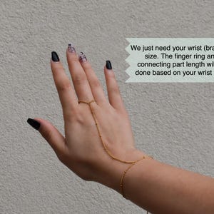 a woman's hand with black and white nail polish