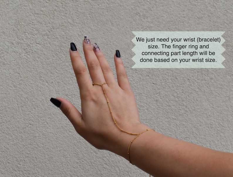 a woman's hand with black and white nail polish