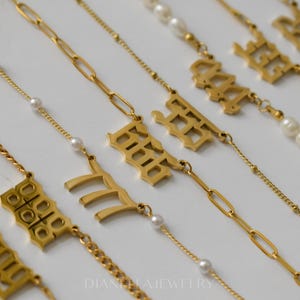 a collection of gold necklaces and pendants with various designs and sizes.