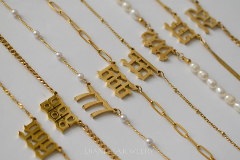 a collection of gold necklaces and pendants with various designs and sizes.