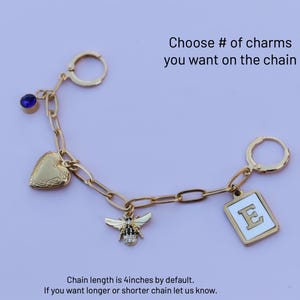 a keychain with a bee, heart, and letter e on it