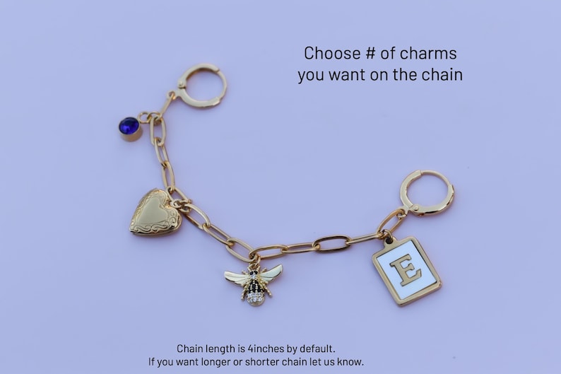 a keychain with a bee, heart, and letter e on it