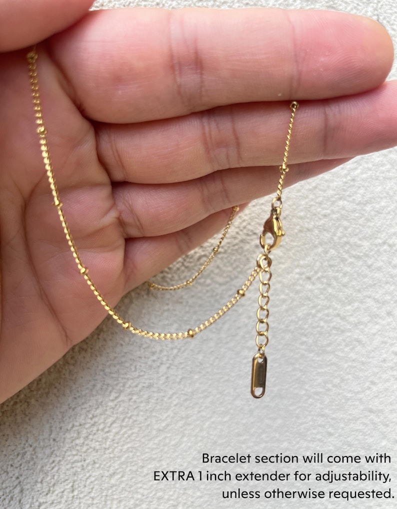a person holding a gold chain in their hand