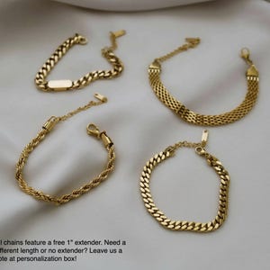 a collection of gold-colored bracelets arranged on a white background.