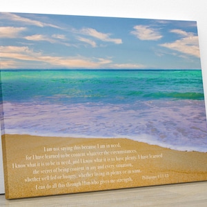 May include: A beach scene with blue sky, white clouds, turquoise water, and white foamy waves crashing on the sandy shore. The image includes a quote about contentment in any situation, from Philippians 4:11-13.