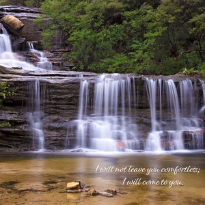 May include: A cascading waterfall flows over moss-covered rocks in a lush green forest. The water is clear and sparkling, and the surrounding foliage is vibrant. The quote "I will not leave you comfortless; I will come to you. John 14:18" is written in white script at the bottom of the image.