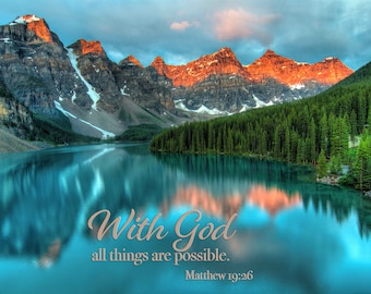 May include: A scenic landscape with a mountain range reflected in a still lake. The mountains are a mix of brown and red, with snow-capped peaks. The lake is a vibrant blue, and the sky is a soft blue with clouds. The text "With God all things are possible. Matthew 19:26" is superimposed on the image.