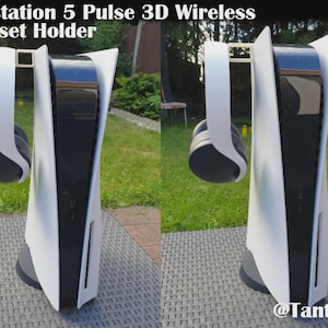 May include: A white and black Playstation 5 Pulse 3D Wireless Headset Holder. The holder has a sleek design with a black base and a white frame. A pair of black and white headphones hangs from the top. The text "Playstation 5 Pulse 3D Wireless Headset Holder" is visible.