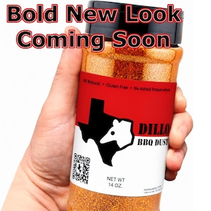 May include: A clear plastic bottle filled with orange BBQ seasoning, featuring a black lid and a label with the text Bold New Look Coming Soon, Dillo BBQ Dust, and Net Wt 14 oz. The label displays a black silhouette of Texas and a QR code.