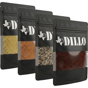 May include: Four black stand-up pouches containing different spices, each featuring a clear window to view the contents. The bags are labeled with the text DILLO and a graphic of the state of Texas. The spices range in color from yellow to red.