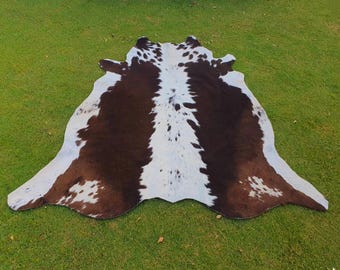 Alfombra de piel de vaca auténtica, color marrón y blanco, estilo rústico occidental, para decoración del hogar.