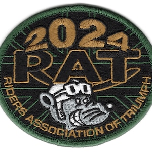 May include: A green, black, and gold embroidered patch with the text "2021 RAT RIDERS ASSOCIATION OF TRIUMPH" and a cartoon rat wearing goggles.