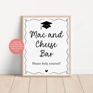May include: A white rectangular sign in a light wood frame featuring black text that reads Mac and Cheese Bar and Please help yourself. The design includes a black graduation cap icon at the top, a small heart at the bottom, and a decorative border.