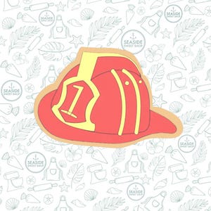 May include: A red and yellow firefighter helmet cookie cutter. The helmet has a yellow number 1 on the front and yellow stripes. The cookie cutter is on a white background with a pattern of baking-themed illustrations and the text "SEASIDE SWEET SHOP".