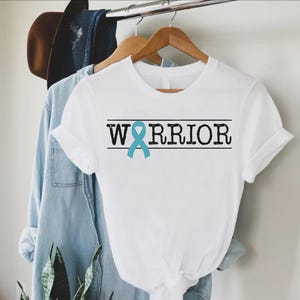 a white shirt with a blue ribbon on it