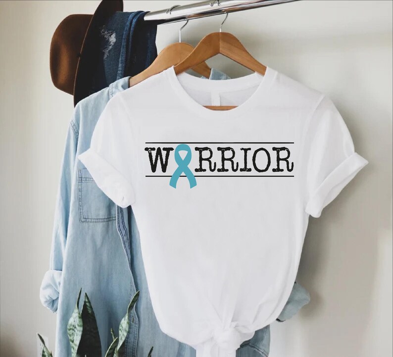 a white shirt with a blue ribbon on it