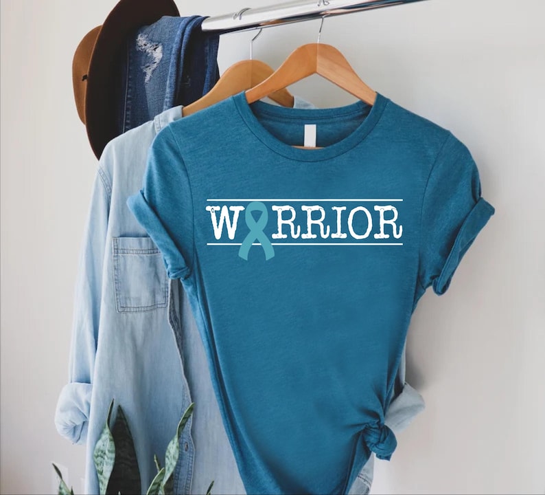 a blue shirt with the word warrior on it