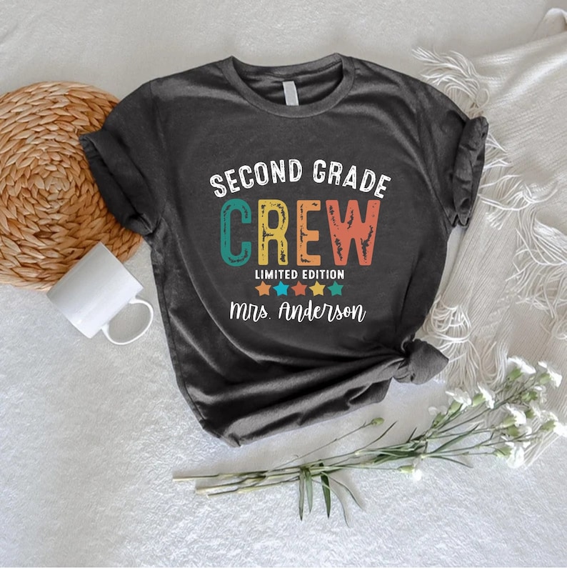 a t - shirt that says second grade crew on it