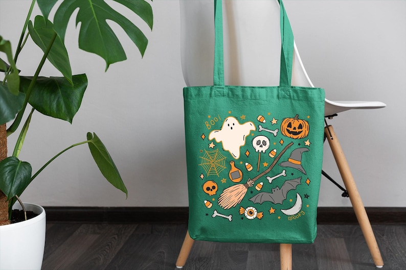 a green trick or treat bag sitting on a chair next to a potted plant