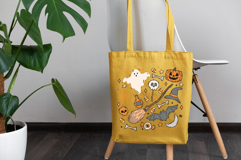 a yellow halloween bag sitting on top of a chair next to a potted plant