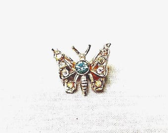 Broche de mariposa vintage con diamantes de imitación azul claro y blanco en tono dorado