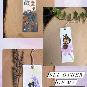 May include: Three handmade bookmarks featuring watercolor illustrations of a butterfly, a bumblebee, and a monarch butterfly. The bookmarks are on wooden surfaces and have a rustic aesthetic. The text "See other of my creations" is visible in the image.