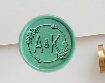 May include: A green wax seal with the initials "A&K" in a circle surrounded by floral designs.