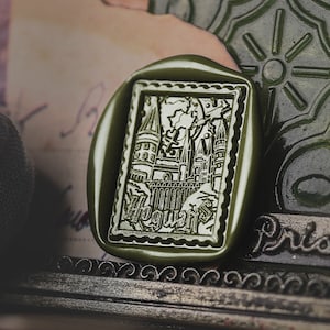 May include: A green wax seal with an image of Hogwarts castle and the text "Hogwarts" in a decorative font.
