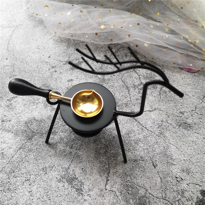 Peut inclure: Support de sceau en cire en m&eacute;tal noir en forme de cerf avec une cuill&egrave;re en m&eacute;tal dor&eacute; sur le dessus.