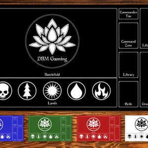 May include: Black and white playmat with a lotus flower design and the text "DBM Gaming". The playmat has sections for a battlefield, lands, library, exile, graveyard, command zone, life total, and commander tax.