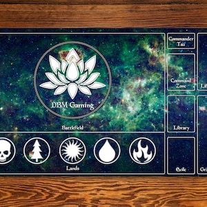 May include: A green and blue galaxy-themed playmat with a white lotus flower logo and the text "DBM Gaming". The playmat has sections for a battlefield, lands, library, exile, graveyard, command zone, life total, and commander tax.