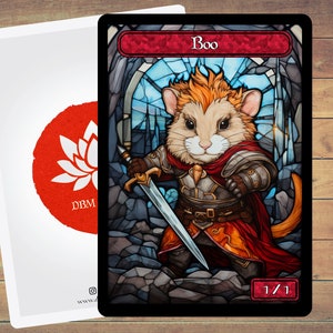 May include: A fantasy art card featuring a mouse warrior named "Boo" holding a sword, set against a stained-glass window background. The card has a red banner with the name "Boo" and the stats "1/1". A second card with a red lotus flower logo is visible.