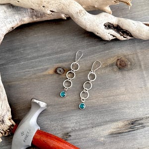 Silver circle dangle earrings with Topaz bezeled stone