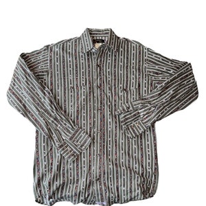 May include: A long-sleeved button-down shirt with a green, white, and red striped pattern. The shirt has a pointed collar and a single chest pocket.