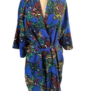 May include: A blue floral print robe with a self-tie sash. The robe has a long sleeve and a relaxed fit.