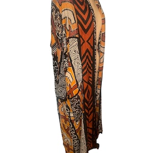 May include: A long, black, brown, and white patterned kimono with a geometric design.
