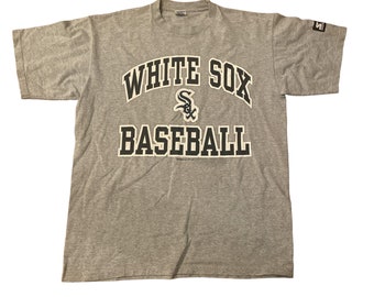 May include: Gray t-shirt with a white and black graphic of the Chicago White Sox logo and the text "White Sox Baseball".